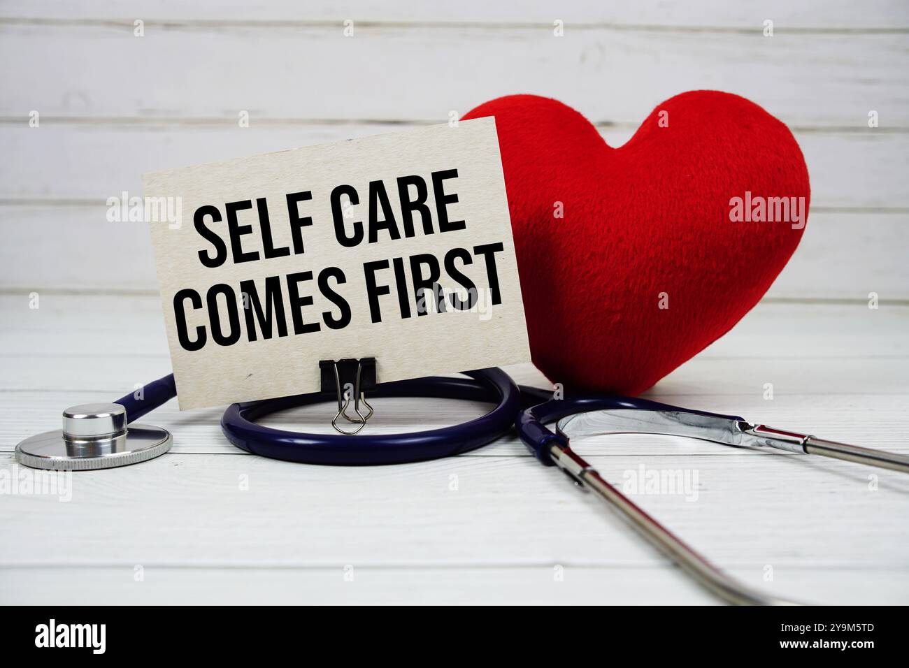 Self Care Comes First text message on paper card with stethoscope on ...