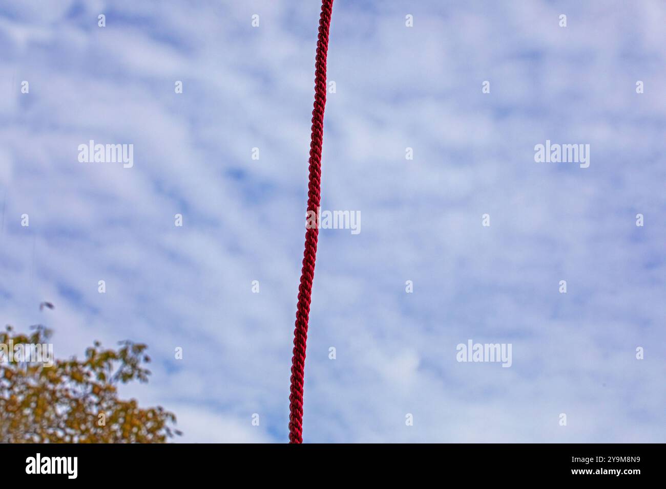strong rope against the sky with clouds. Construction work at height ...