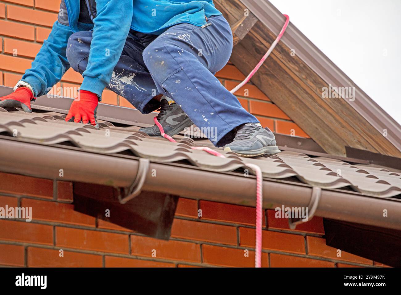 worker preparing before installing solar panels on the roof. Saving energy resources of the earth Stock Photo
