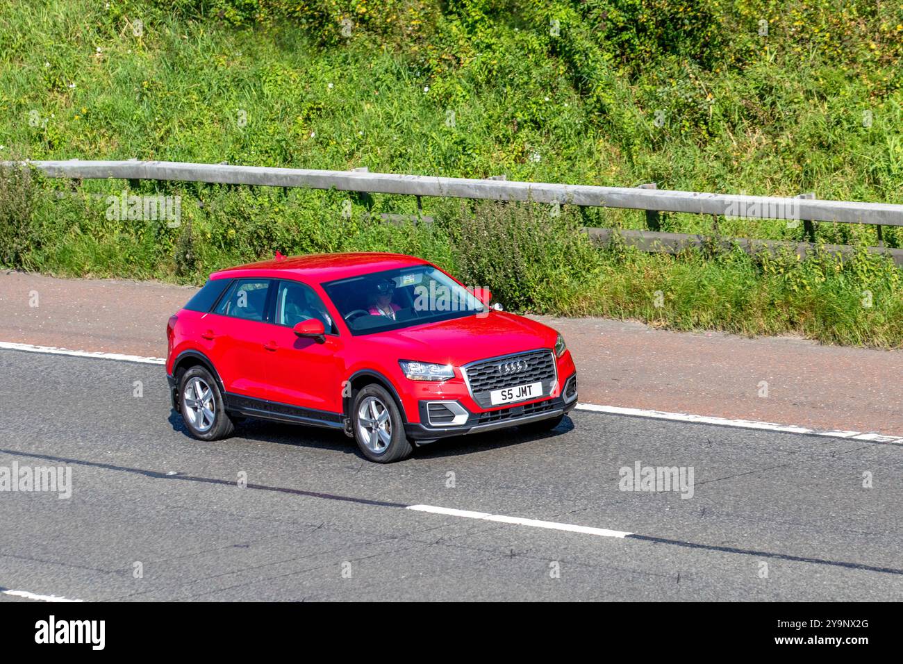 2017 Red Audi Q2 Sport TFSI S-A ,  turbocharged 2.0-litre petrol engine travelling on the M6 motorway UK Stock Photo