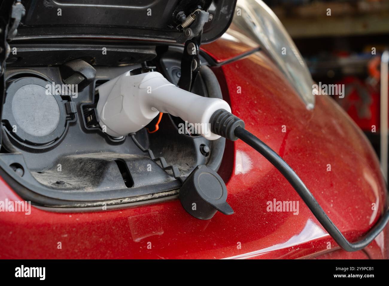 Electric Vehicle plugged in to charge Stock Photo - Alamy