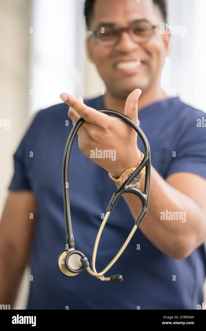 Close up of man holding stethoscope Stock Photo