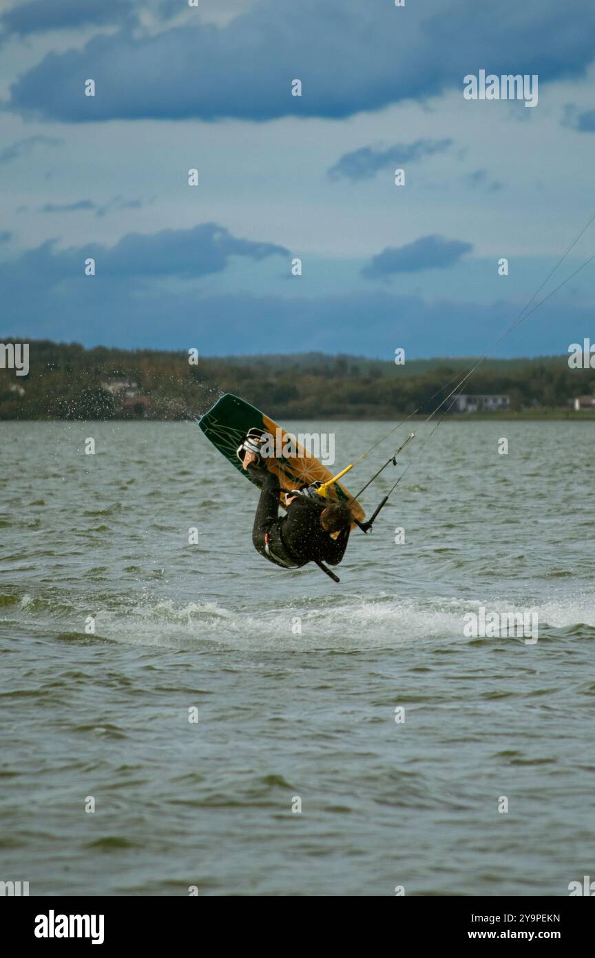 Man do tricks with his board practicising kitesurf jump in the air ...