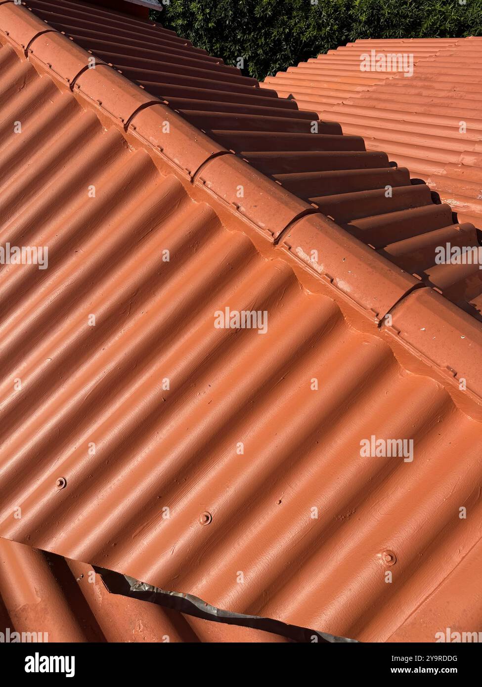 Cleaned and freshly maintained corrugated roof with a clear protective coating. - Smartphone Captured Stock Image