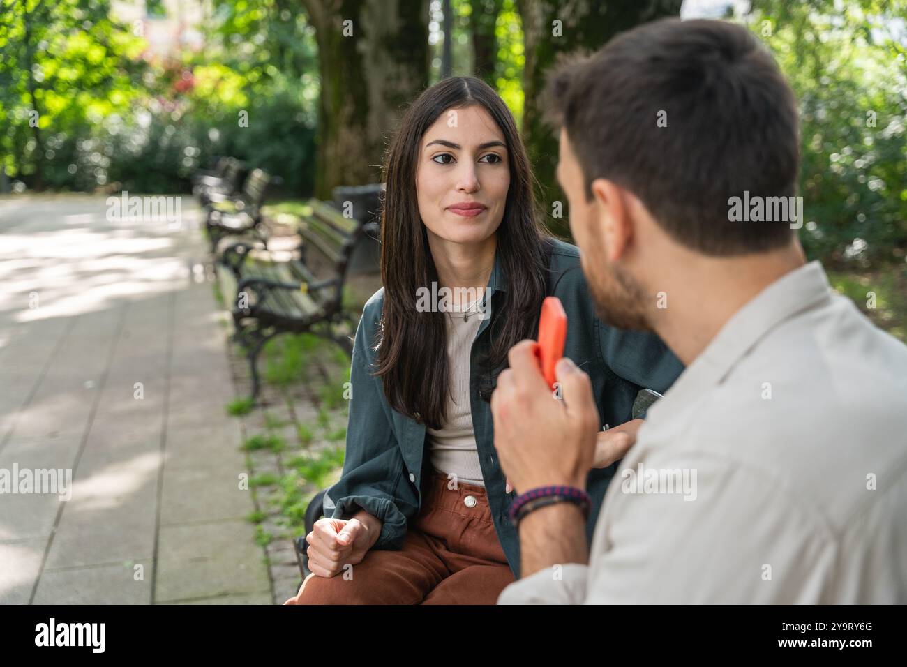 Street interviews. Young freelance independent journalist and vlogger interview random people on the street about their life. Man recording audio soun Stock Photo
