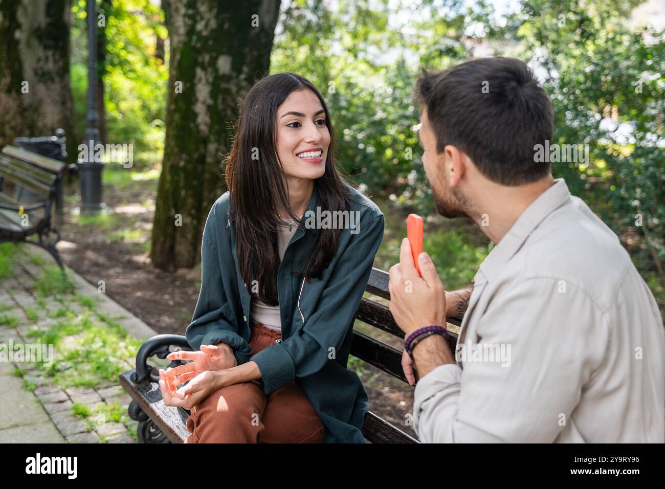Street interviews. Young freelance independent journalist and vlogger interview random people on the street about their life. Man recording audio soun Stock Photo