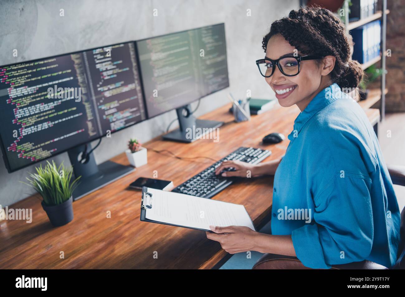 Photo of pretty young girl paperholder report working coding wear blue ...