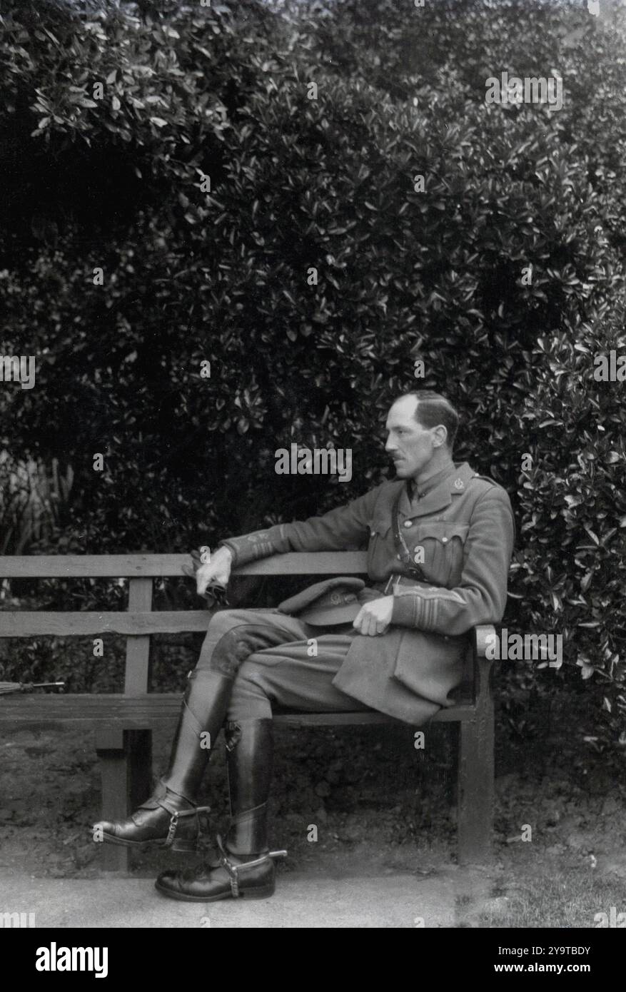 circa 1930s, historical, senior Army Officer, Colonel Arthur E. Irvine of the RAMC sitting on a bench. Of Scottish-Irish descent and educated in both Belfast and Dublin, Irvine served in WWI and was awarded the D.S.O. Post WWI he served as personal physician to Princess Mary in Egypt and then India, when in 1936 he became honorary surgeon to the Viceroy of India. He and his son Richard, a Major in the KOSB, were keen amateur photographers and filmmakers and their collection of films is housed in the Moving Image Archive at the National Library of Scotland. Stock Photo