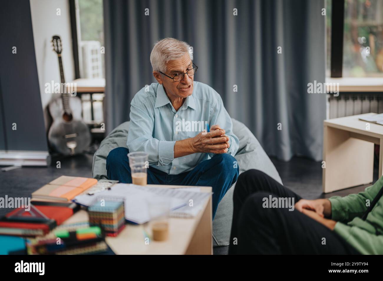 Professor engaging with students in a relaxed environment Stock Photo