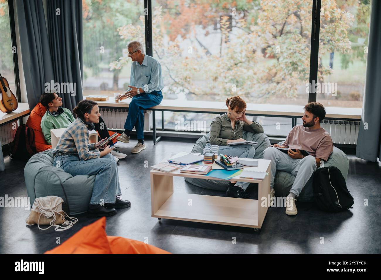 Professor engaging with students in a modern learning space Stock Photo