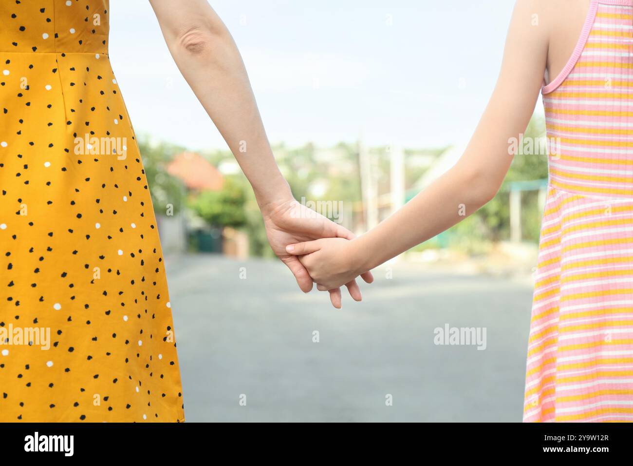 Mother and daughter holding hands outdoors, closeup Stock Photo - Alamy