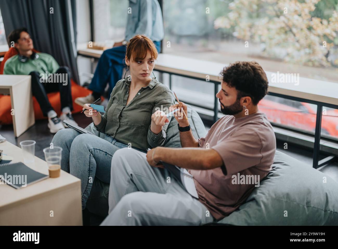 Students engaged in discussion during study group session Stock Photo