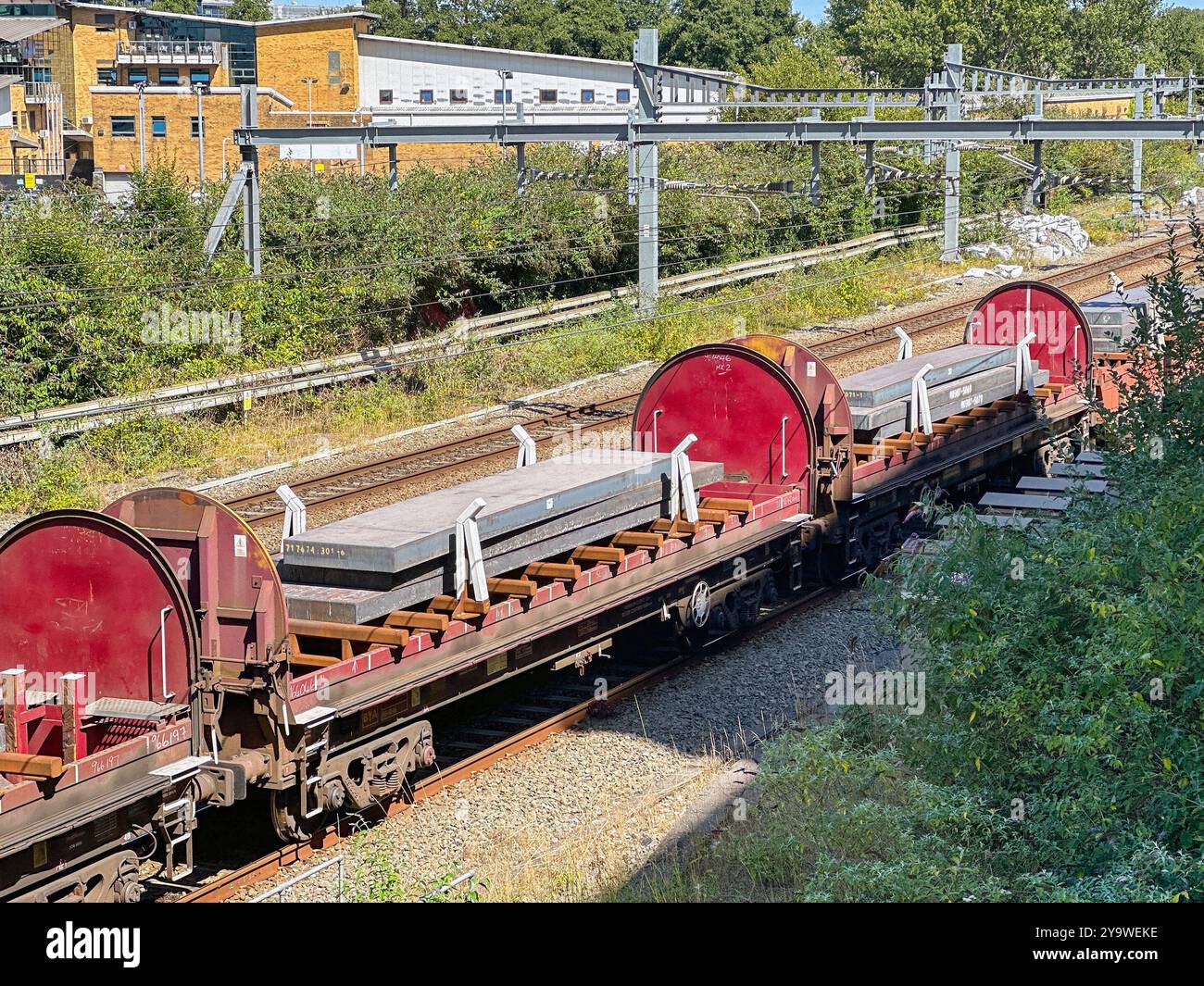 Cardiff, Wales UK - 16 August 2024: Freight train carrying heavy slabs of steel - Smartphone Captured Stock Image