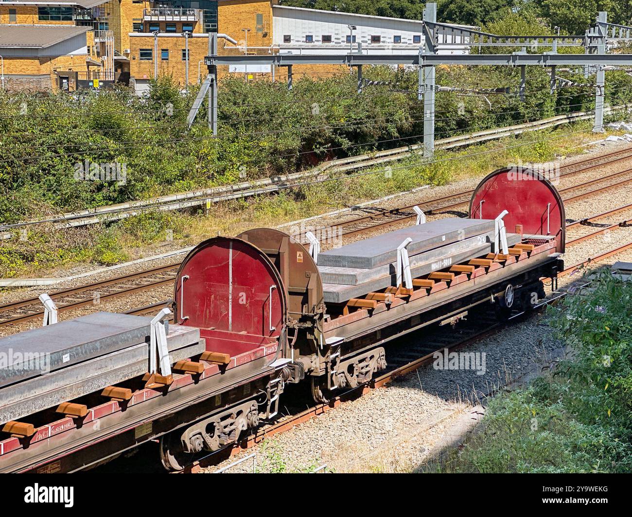Cardiff, Wales UK - 16 August 2024: Freight train carrying heavy slabs of steel - Smartphone Captured Stock Image