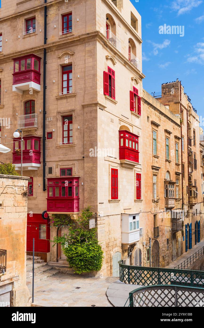 Traditional Maltese buildings with colourful balconies in historic old town of Valletta, Malta Stock Photo