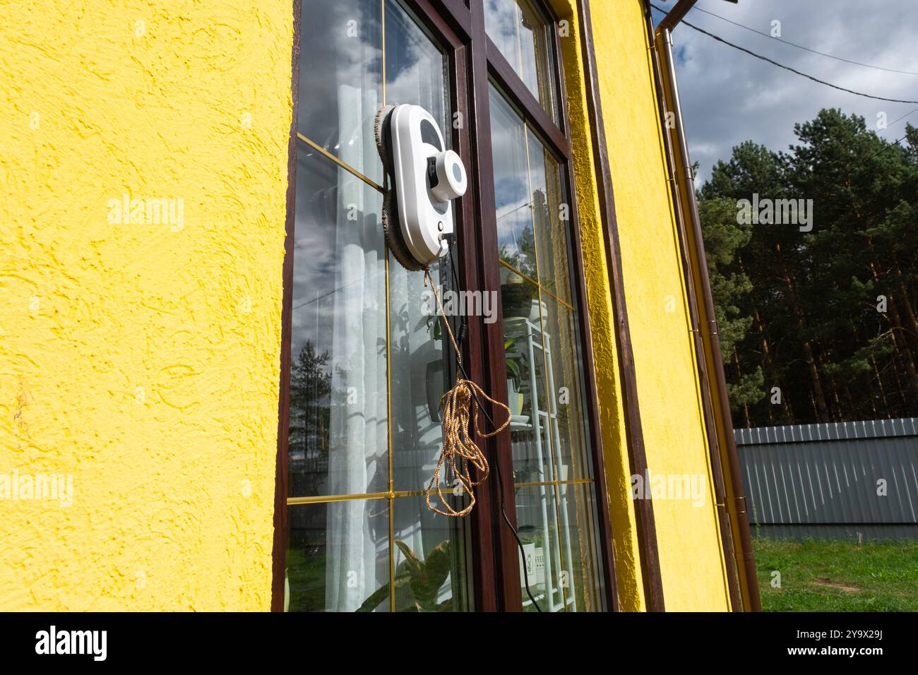 A window cleaner robot cleans windows in a house from the outside ...