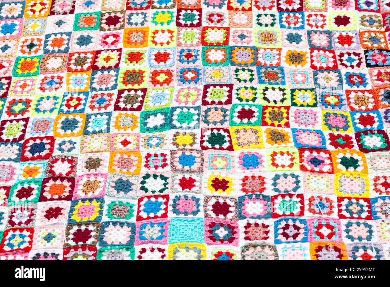 Multi colored blanket in wool, geometric background, retro decorative pattern Stock Photo