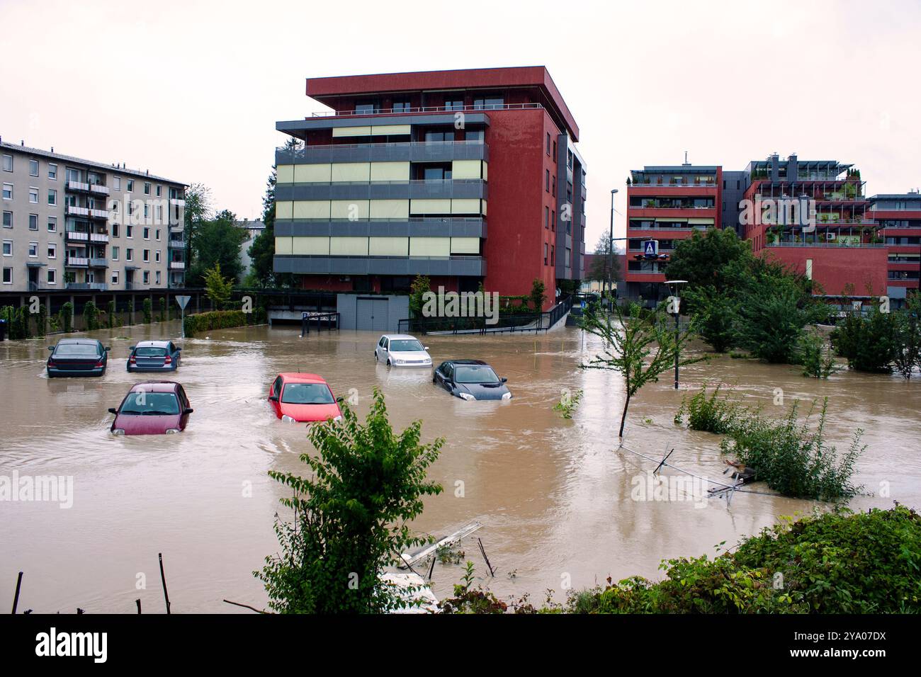 Flooded urban area with submerged cars and residential buildings after heavy rainfall – the impact of a natural disaster on the city. Insurance action Stock Photo