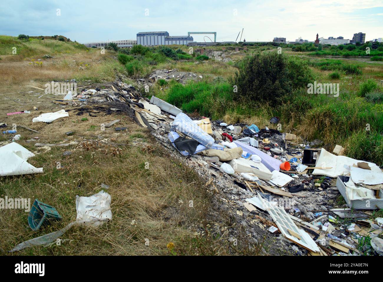 household and construction waste dumped in ditch on derelict industrial land in Teesside Stock Photo