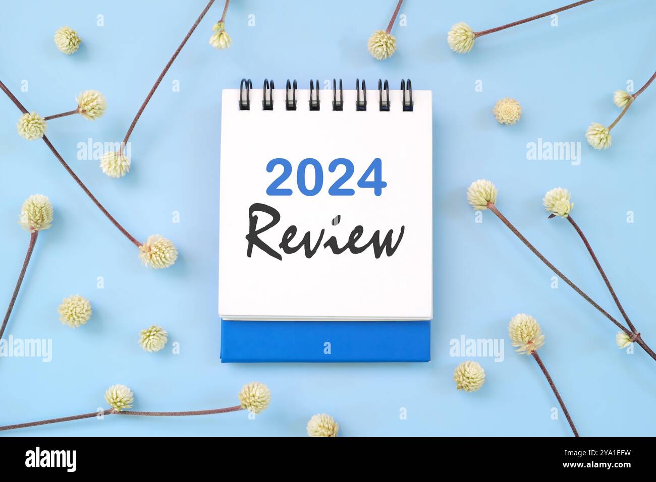 2024 year in review concept. Note typography in blue background flat lay. Stock Photo