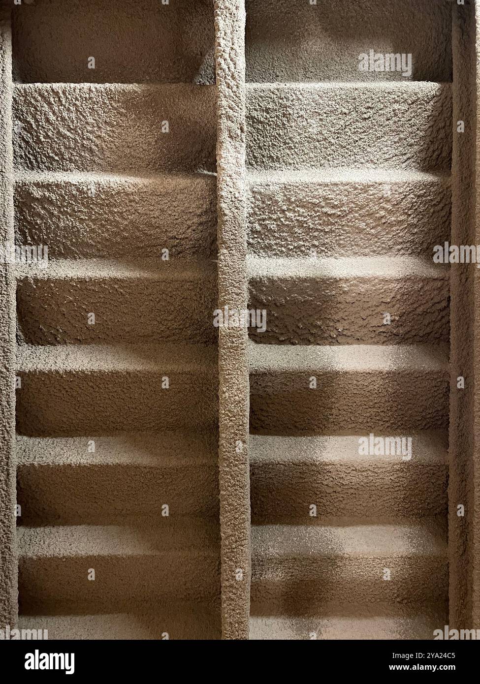 Raw design expose appearance underneath the stairway when look up, giving off an industrial old school look rough surface. Compose in a symmetry. - Smartphone Captured Stock Image