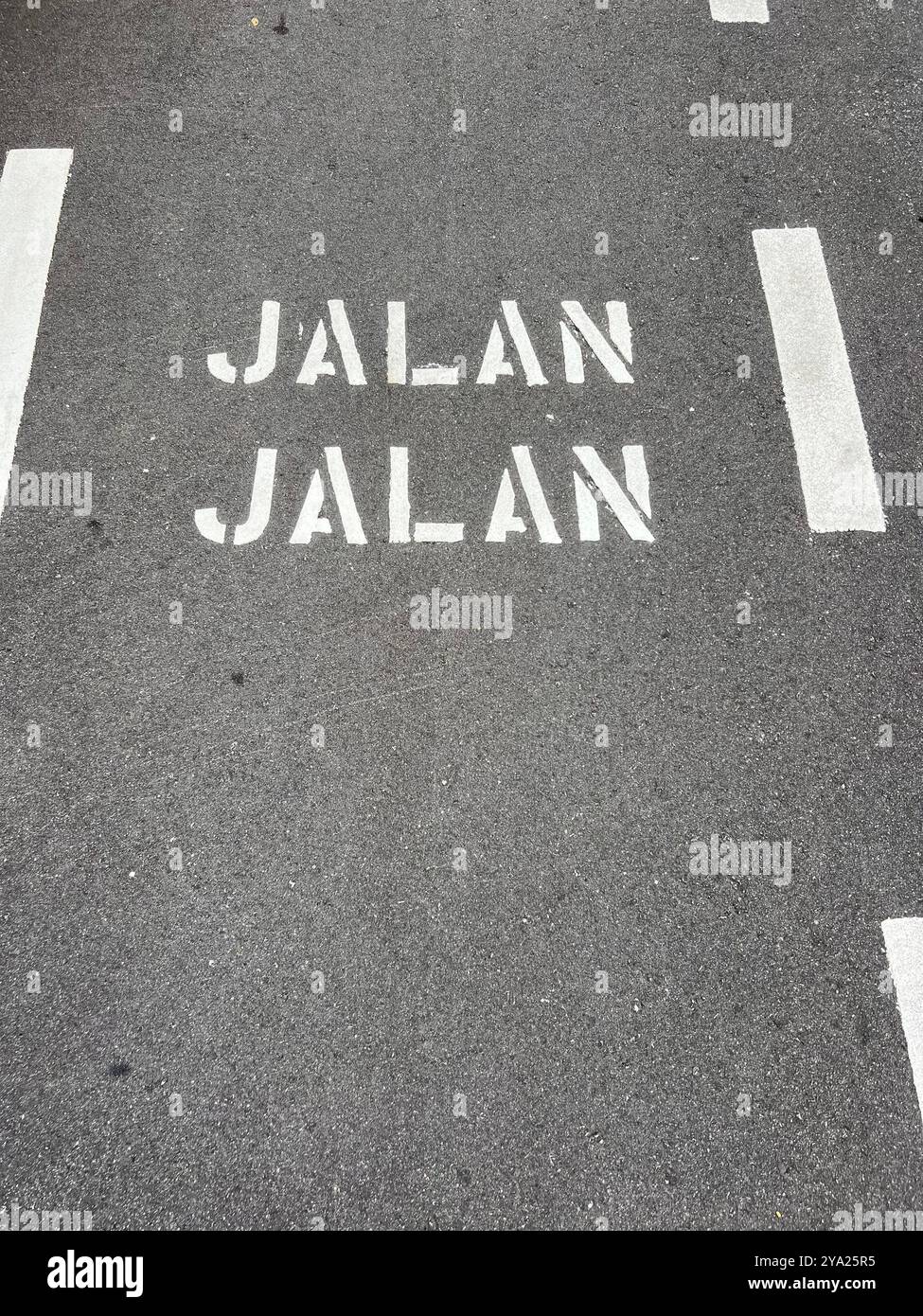 Jalan Jalan in Malay language, a sign on the road to remind people to walk along this stretch. - Smartphone Captured Stock Image