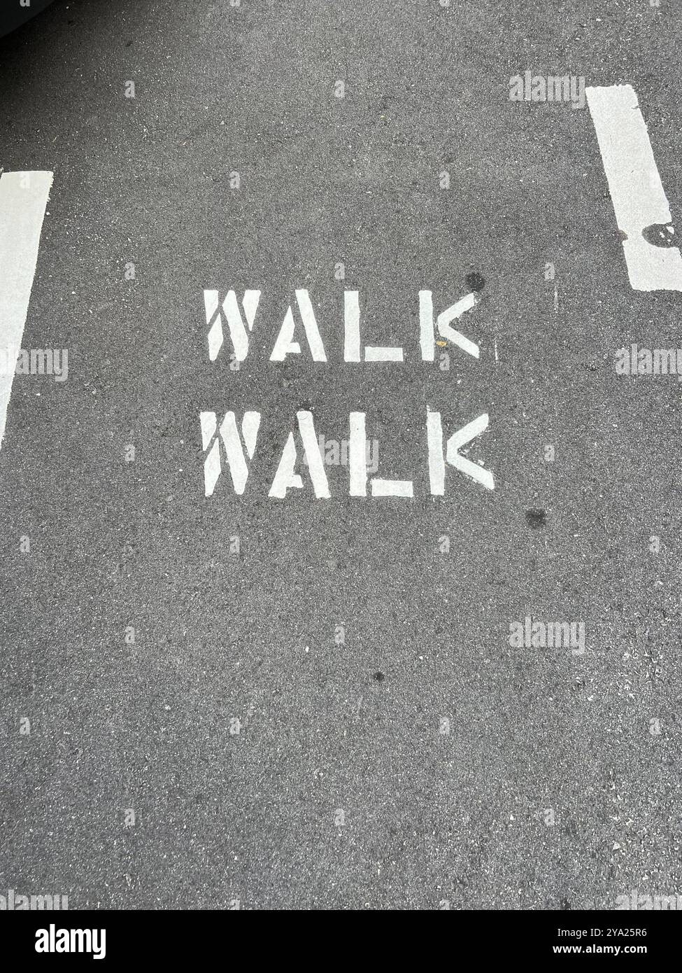 Walk walk sign on the road to remind people to walk along this stretch. - Smartphone Captured Stock Image