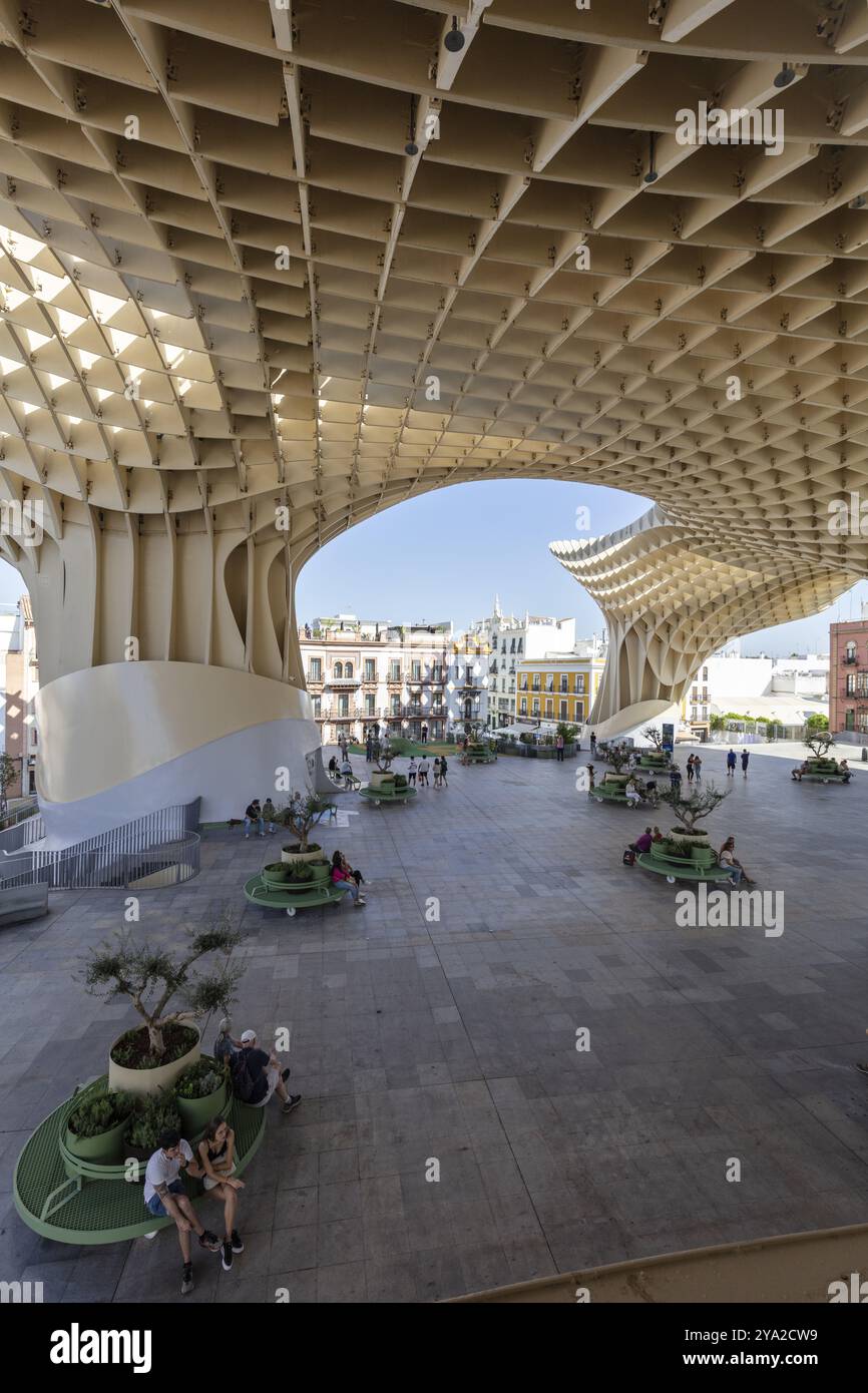 Modern architecture of the Metropol Parasol with people enjoying the shade in the square, Seville Stock Photo