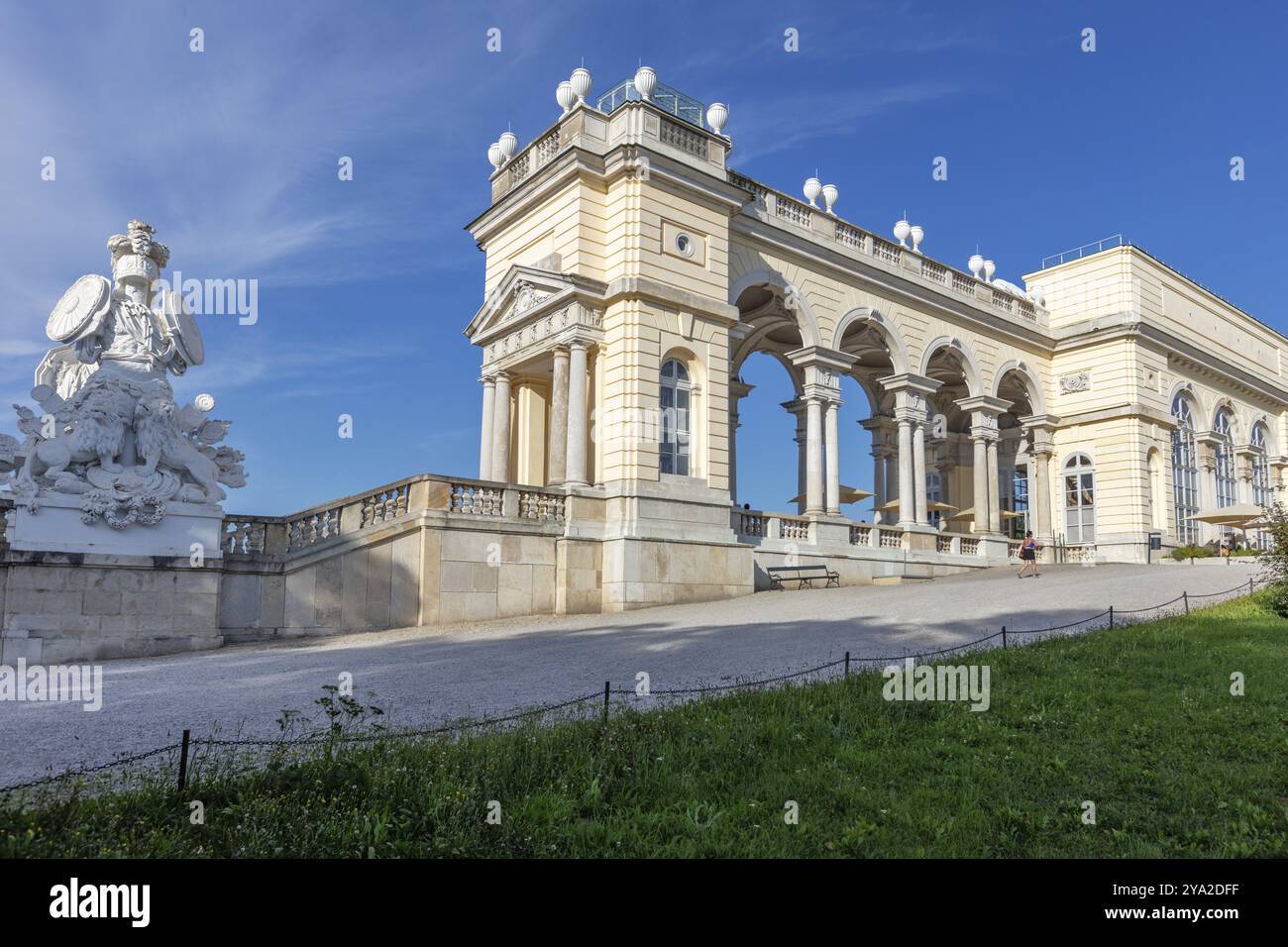 Impressive building with decorative sculptures and columns against a clear sky, Vienna Stock Photo