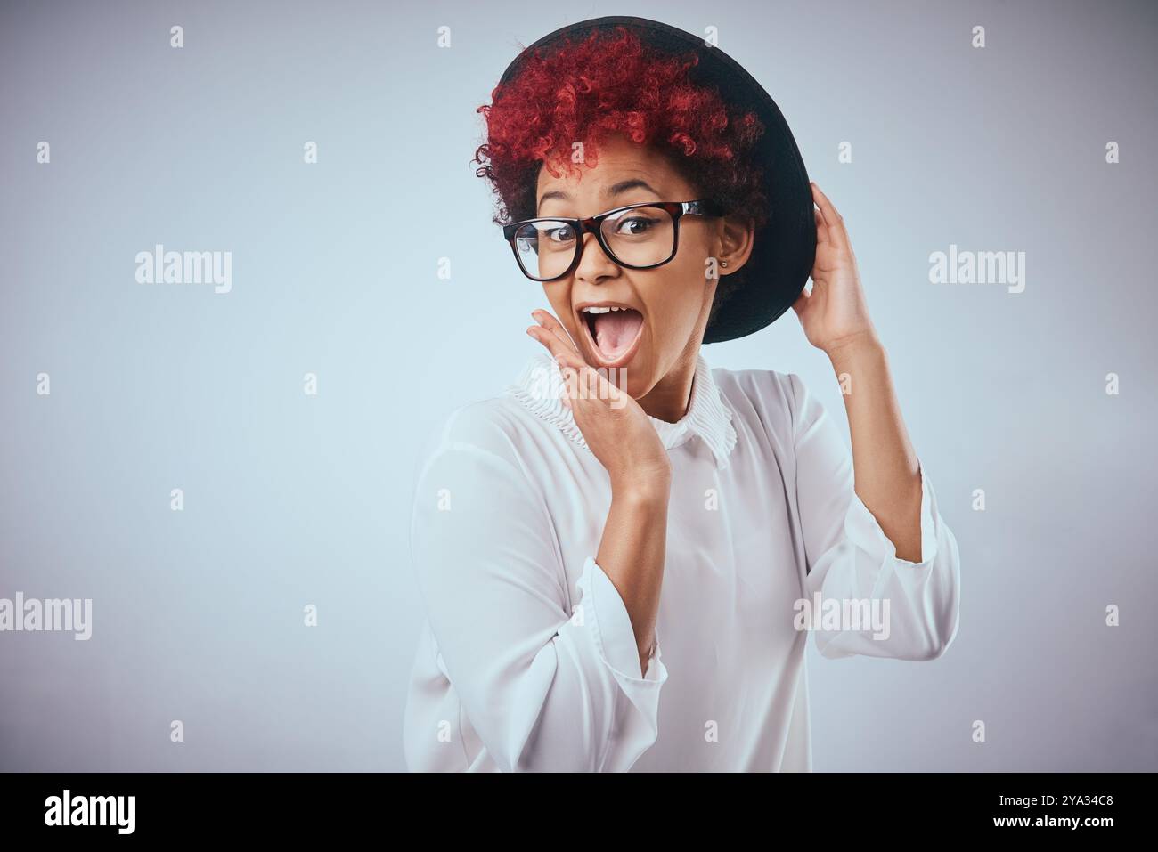 African woman, silly and surprise portrait with fashion and hipster style with wow and happy smile. Studio, glasses and trendy eyewear with minimalist Stock Photo