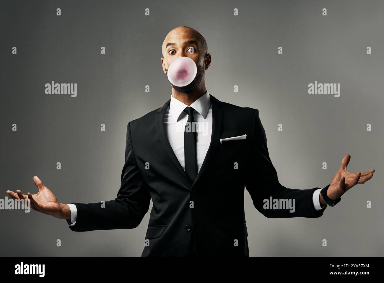 Portrait, bubblegum and confused business man, surprise or question on gray studio background. Face, blow gum and African person in suit for fashion Stock Photo