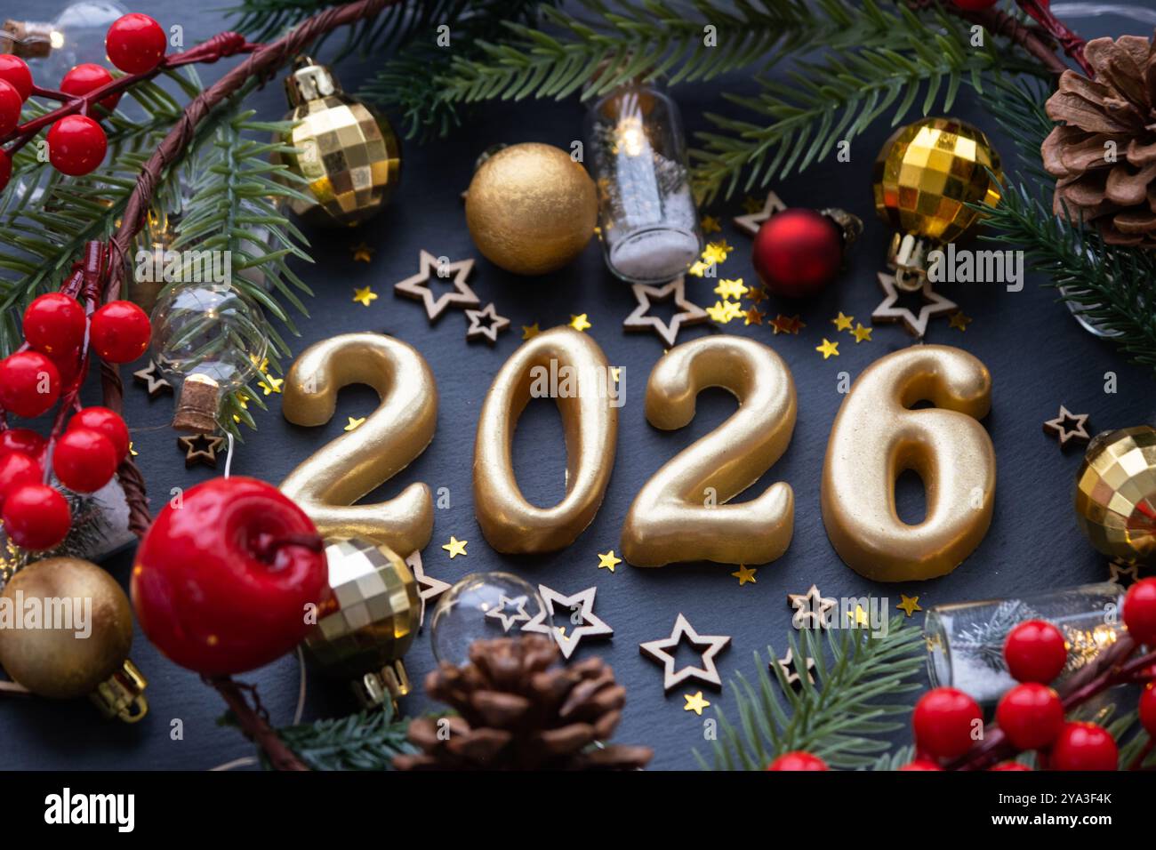 The golden figures 2026 made of candles on a black stone slate