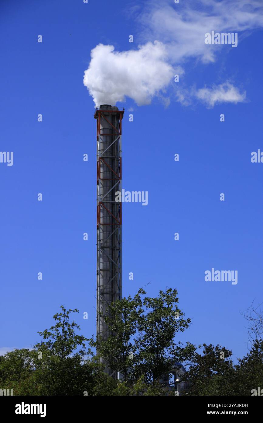 Chimney with white smoke coming out in front of a blue sky Stock Photo ...