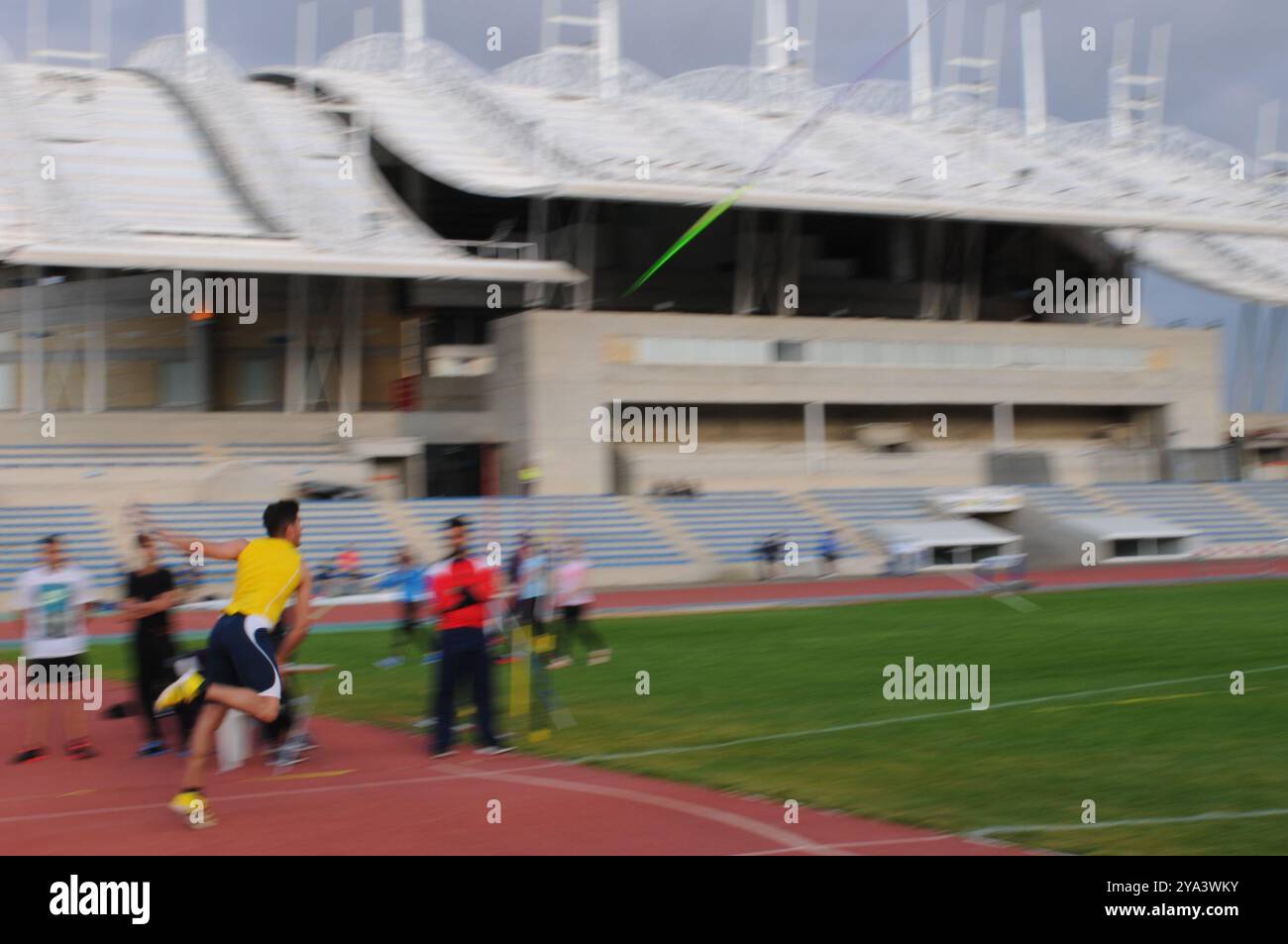 Athlete throwing javelin at track and field competition in stadium ...