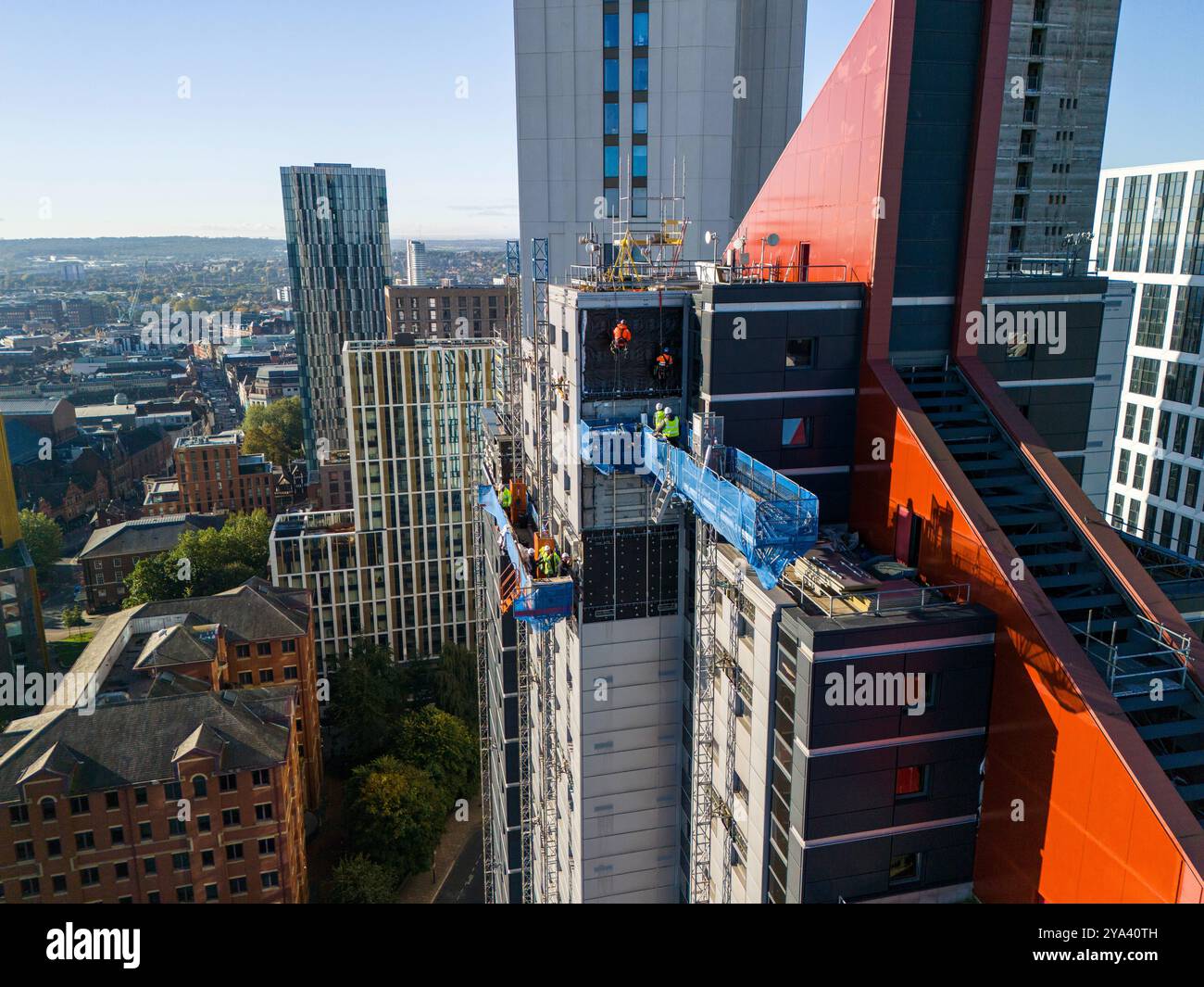 Aerial image of  construction workers at the top of a high rise in Leeds, United Kingdom. Stock Photo