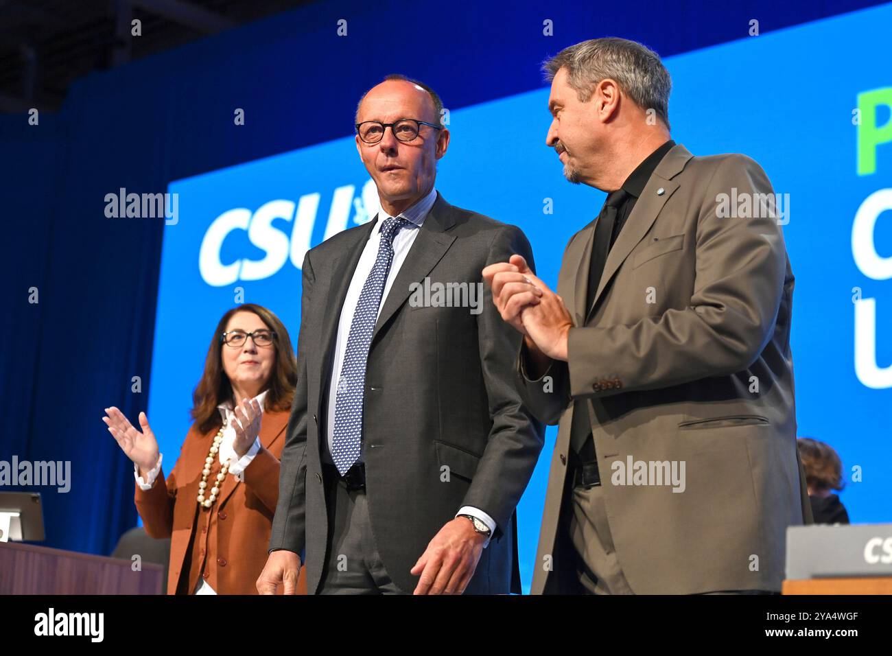 From left: Friedrich MERZ (CDU Chairman and Chancellor candidate) during his speech. Markus SOEDER (Prime Minister of Bavaria and CSU Chairman) on the podium, celebrating. CSU Party Congress 2024 on October 11th and 12th, 2024 AUGSBURG TRADE FAIR? Stock Photo