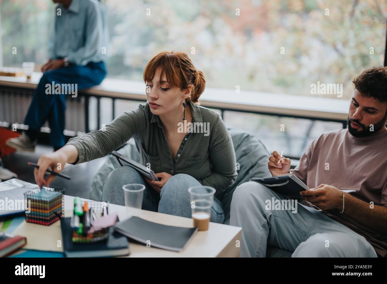 Professor engaging with attentive students in a study session Stock Photo