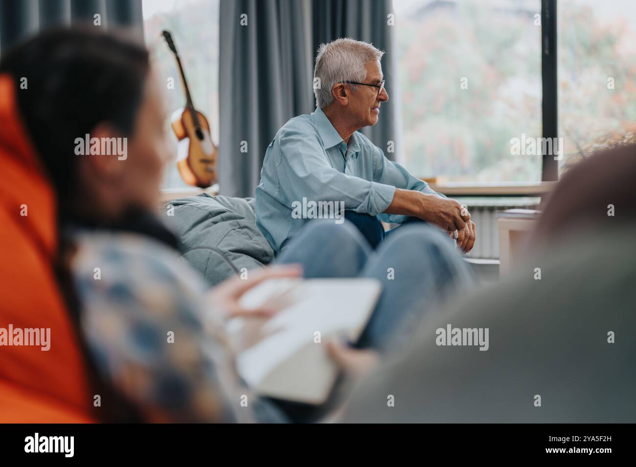 Professor engaging with students in a relaxed classroom setting Stock Photo