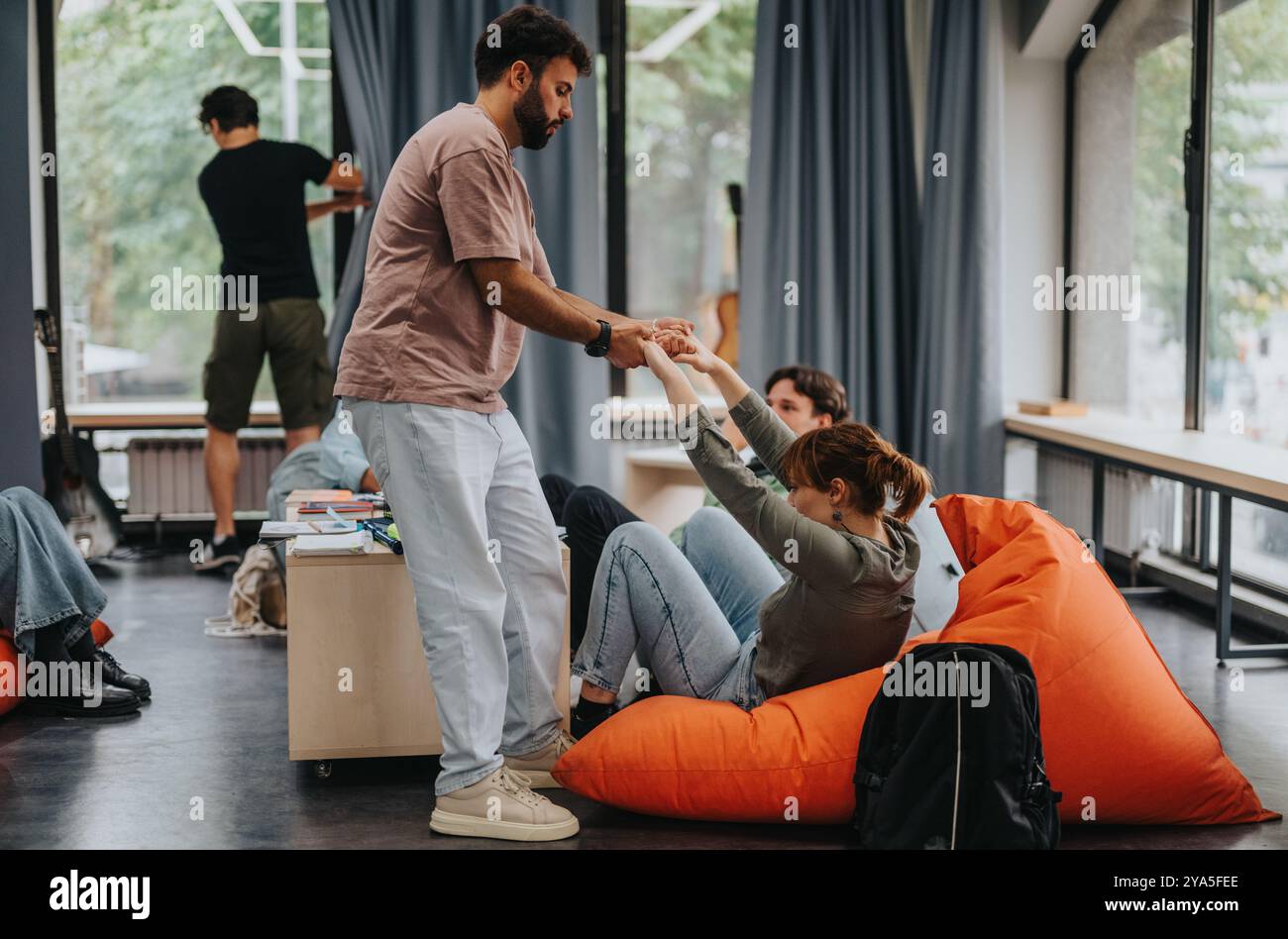 Engaging professor interacting with students in modern classroom setting Stock Photo