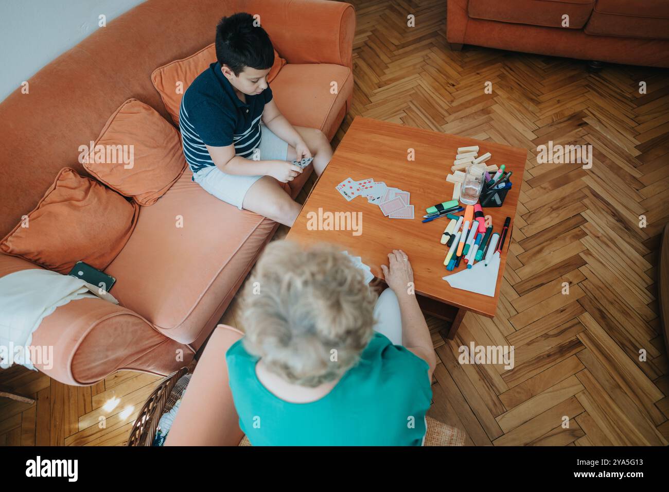 Boy playing cards with grandmother at home on a cozy afternoon Stock ...