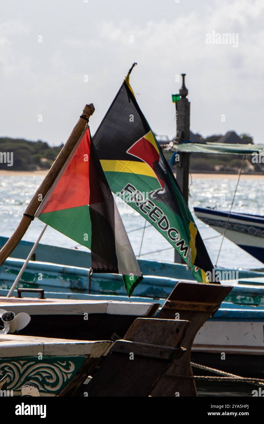 Lamu, Kenya. 09th Oct, 2024. The flag of the State of Palestine is seen flying alongside a flag bearing the word 'Freedom' and featuring the face of Bob Marley, the legendary Jamaican reggae musician, both hoisted on boats. Lamu Island, a UNESCO World Heritage Site, is one of Kenya's oldest towns, is renowned for its rich traditional culture and tourism. The island's architecture reflects its long history, with well-preserved ancient buildings. Credit: SOPA Images Limited/Alamy Live News Stock Photo