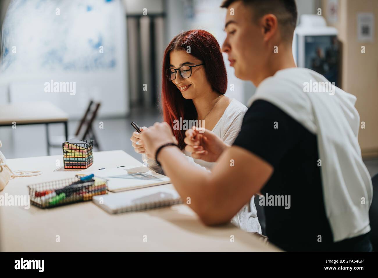 Students collaborating creatively in a modern study environment Stock Photo
