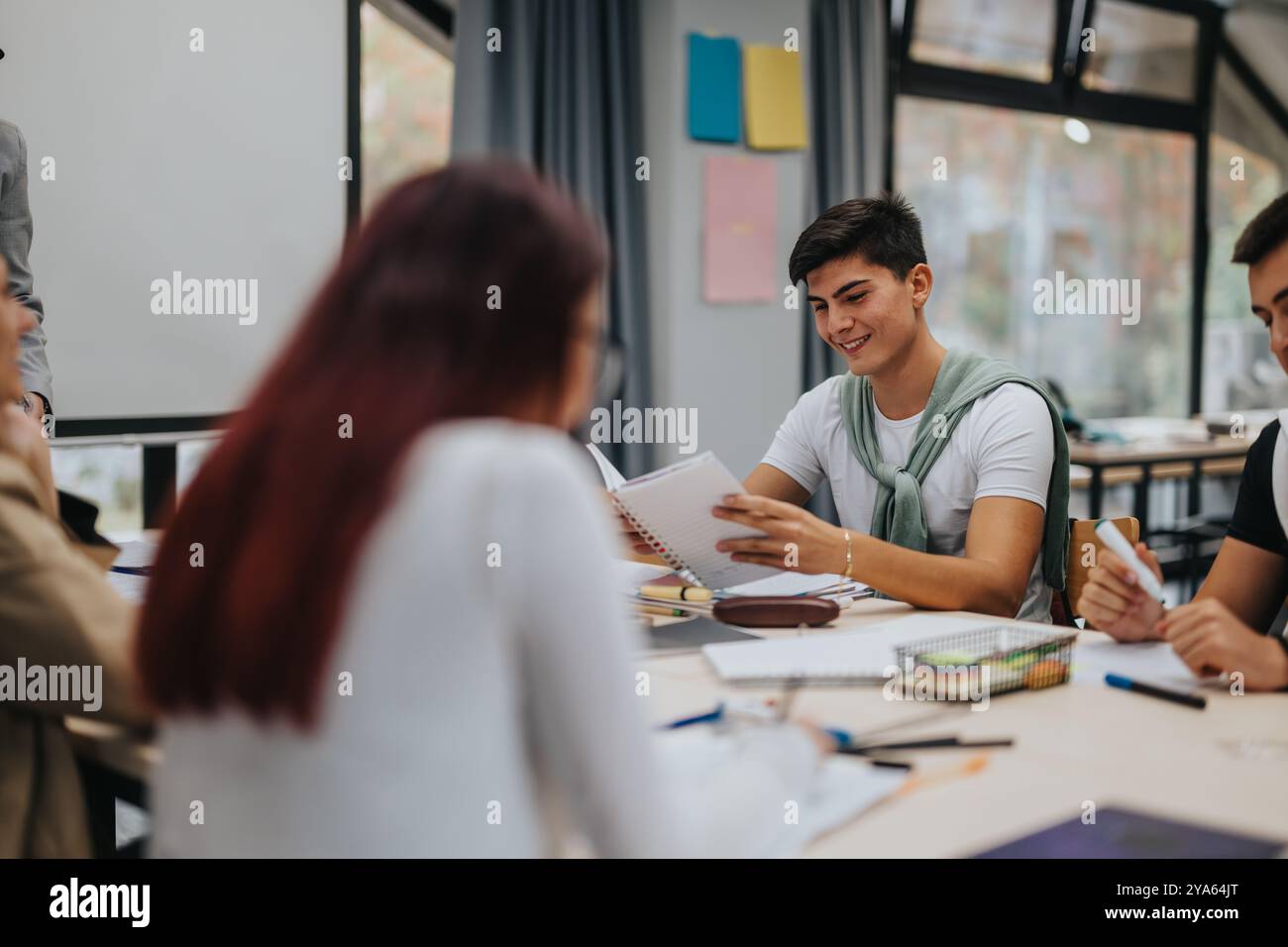 High school students collaborating in a bright classroom Stock Photo
