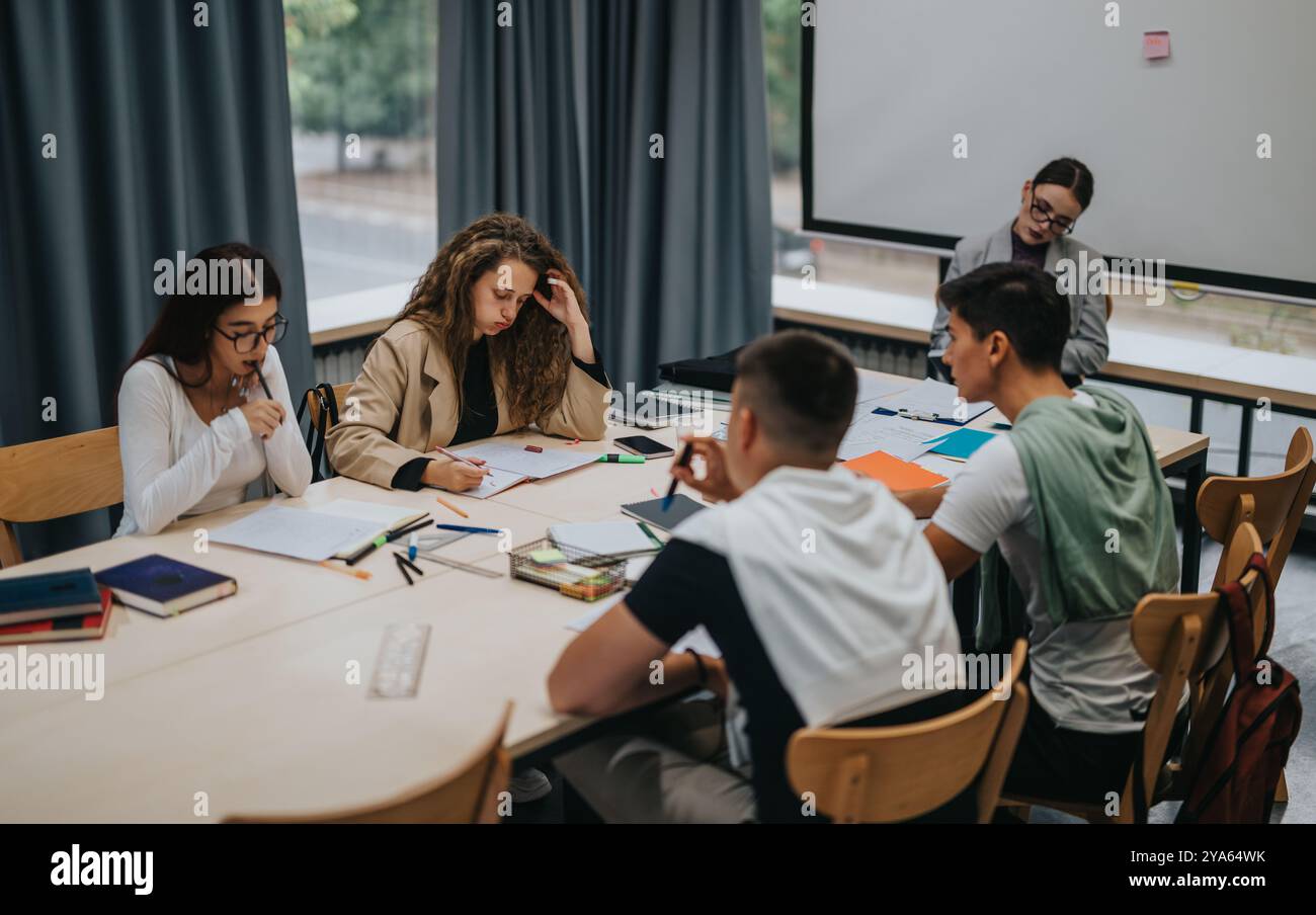 Students collaborating in a group study session at school library Stock Photo