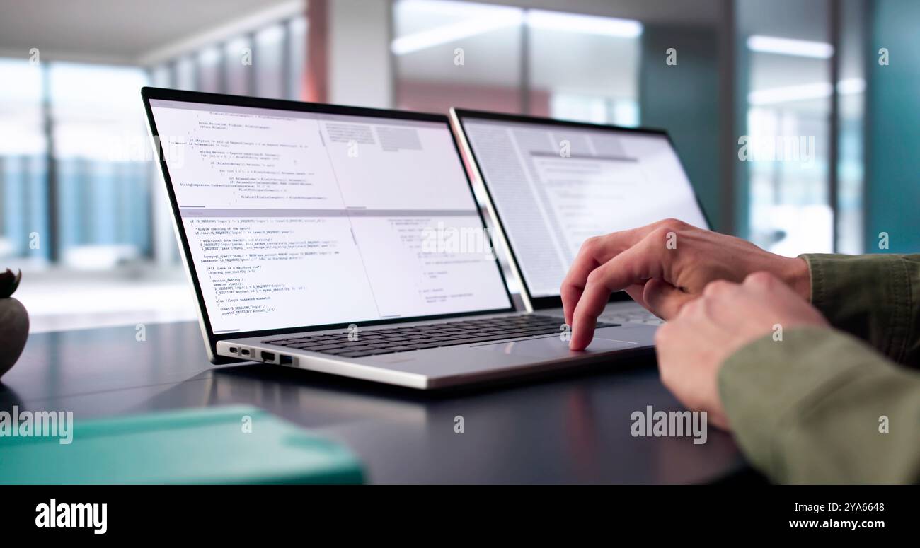 Coder Using Computer At Desk. Web Developer Stock Photo