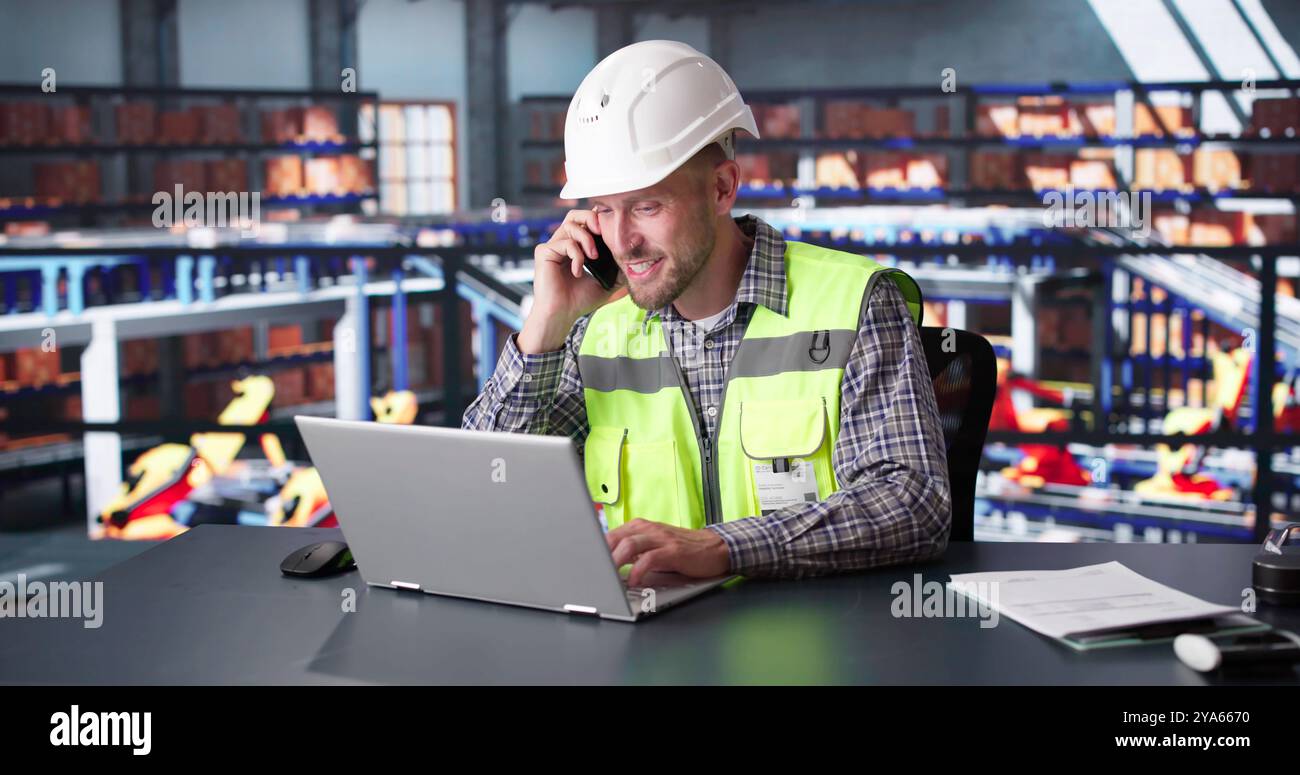 Man Staff In Parcel Delivery Center Using Computer Stock Photo