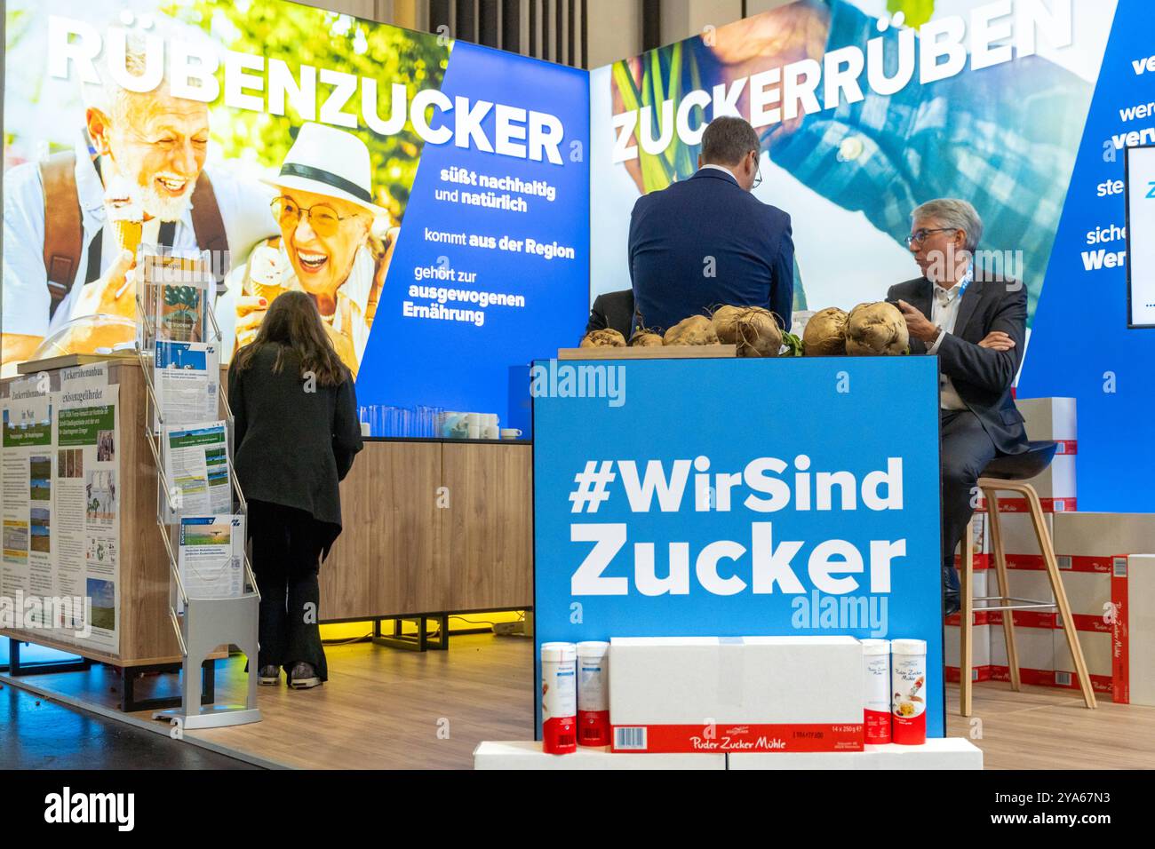 Augsburg, Bavaria, Germany - October 11, 2024: Südzucker exhibition stand at the CSU party conference.The stand advertises the benefits of beet sugar, including sustainable and regional production, with large banners *** Südzucker-Messestand beim CSU-Parteitag. Der Stand wirbt mit großflächigen Bannern über die Vorteile von Rübenzucker, darunter nachhaltige und regionale Produktion Stock Photo