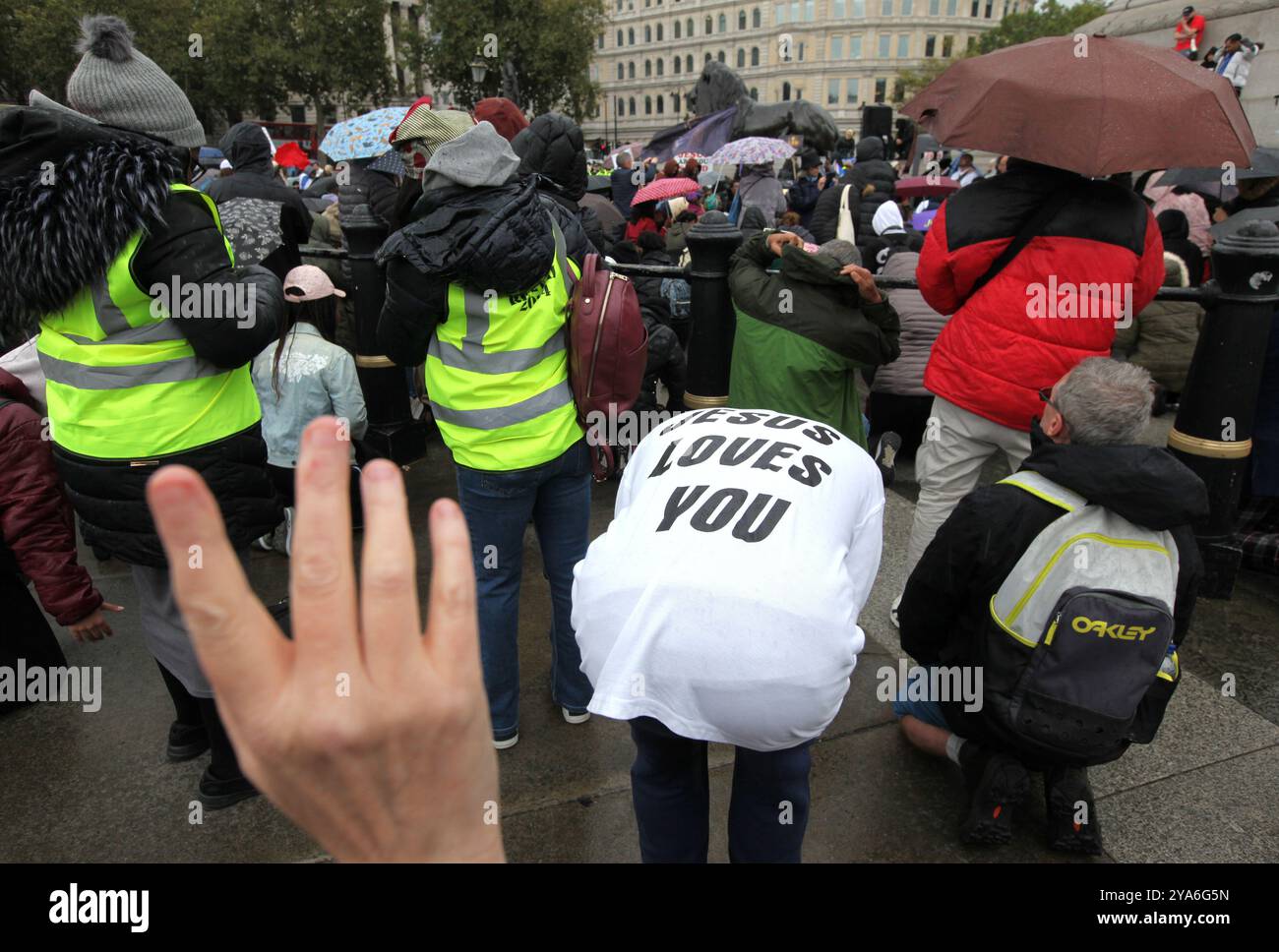 London, England, UK. 12th Oct, 2024. A supporter wearing a ''˜Jesus Loves You t-shirt bends over during prayer in Trafalgar Square during the rally. Supporters come together in Westminster to ''˜Walk for Jesus', celebrate their faith and spread love and positivity in the community. They walk, sing and pray together and share the message of Jesus with everyone around. They argue with all the unrest in the world currently that finding Jesus is the answer. (Credit Image: © Martin Pope/ZUMA Press Wire) EDITORIAL USAGE ONLY! Not for Commercial USAGE! Stock Photo