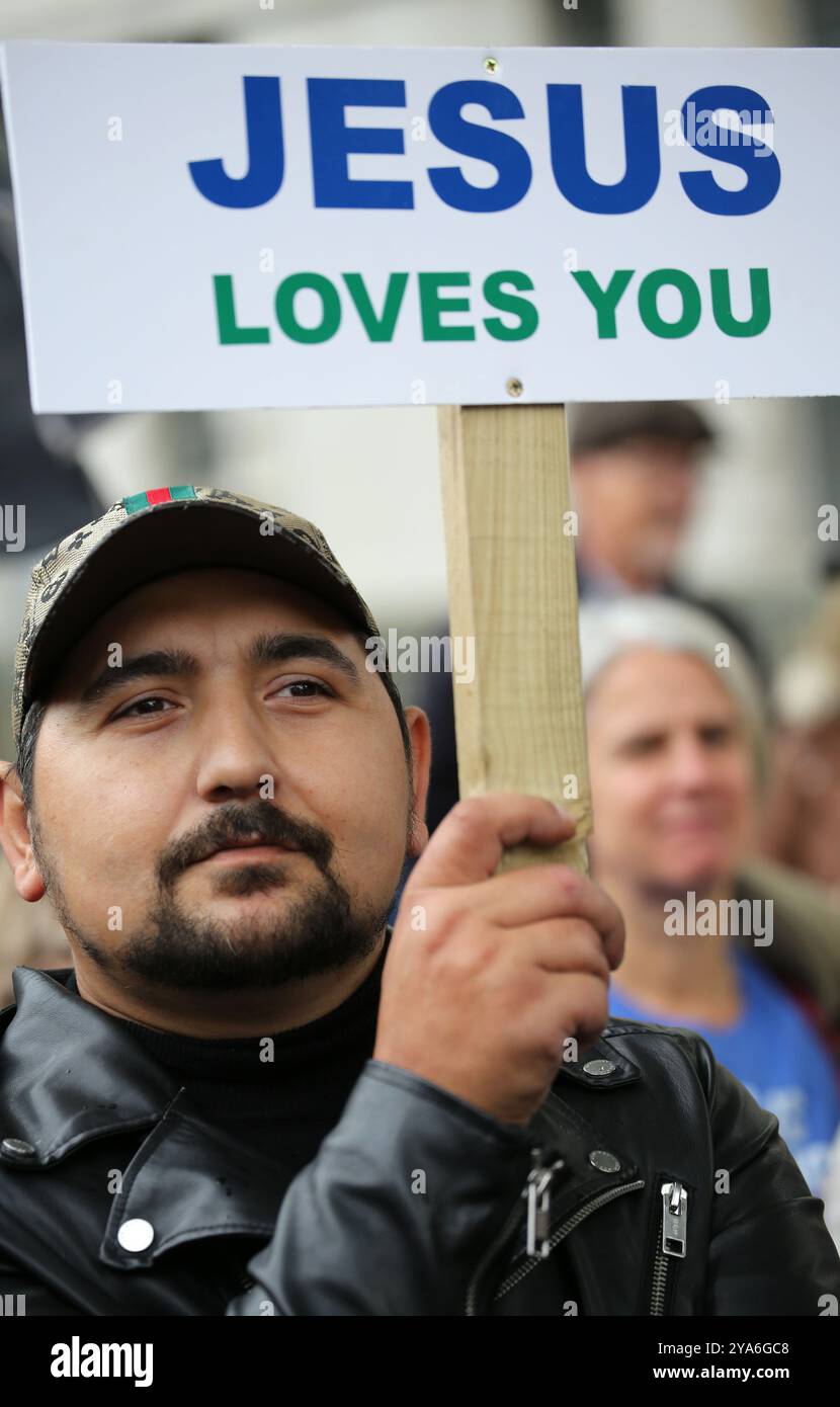 London, England, UK. 12th Oct, 2024. A supporter holds a sign saying ''˜Jesus Loves You' during the rally in Trafalgar Square. Supporters come together in Westminster to ''˜Walk for Jesus', celebrate their faith and spread love and positivity in the community. They walk, sing and pray together and share the message of Jesus with everyone around. They argue with all the unrest in the world currently that finding Jesus is the answer. (Credit Image: © Martin Pope/ZUMA Press Wire) EDITORIAL USAGE ONLY! Not for Commercial USAGE! Stock Photo