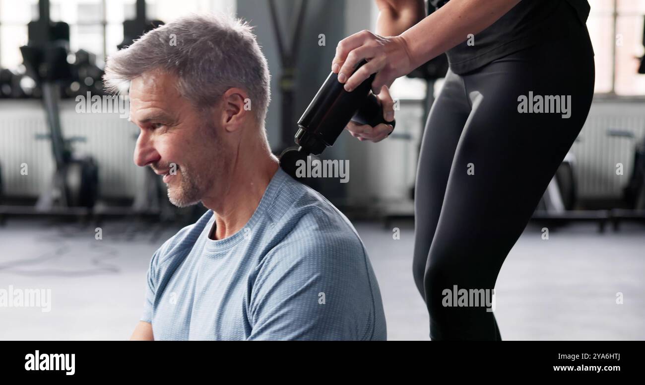 Massage Gun Machine For Muscle Recovery Therapy Stock Photo